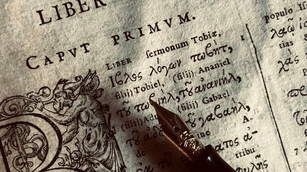 Un manuscrito antiguo en latín, abierto sobre una mesa oscura